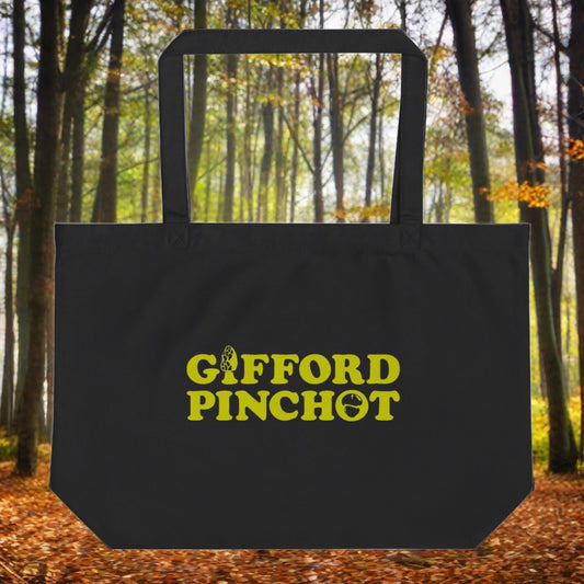 A reusable sturdy black canvas tote-bag featuring the phrase Gifford Pinchot in the color goldenrod. There is a morel mushroom where the letter I should be in the word Gifford and a porcini where the O should be in Pinchot.